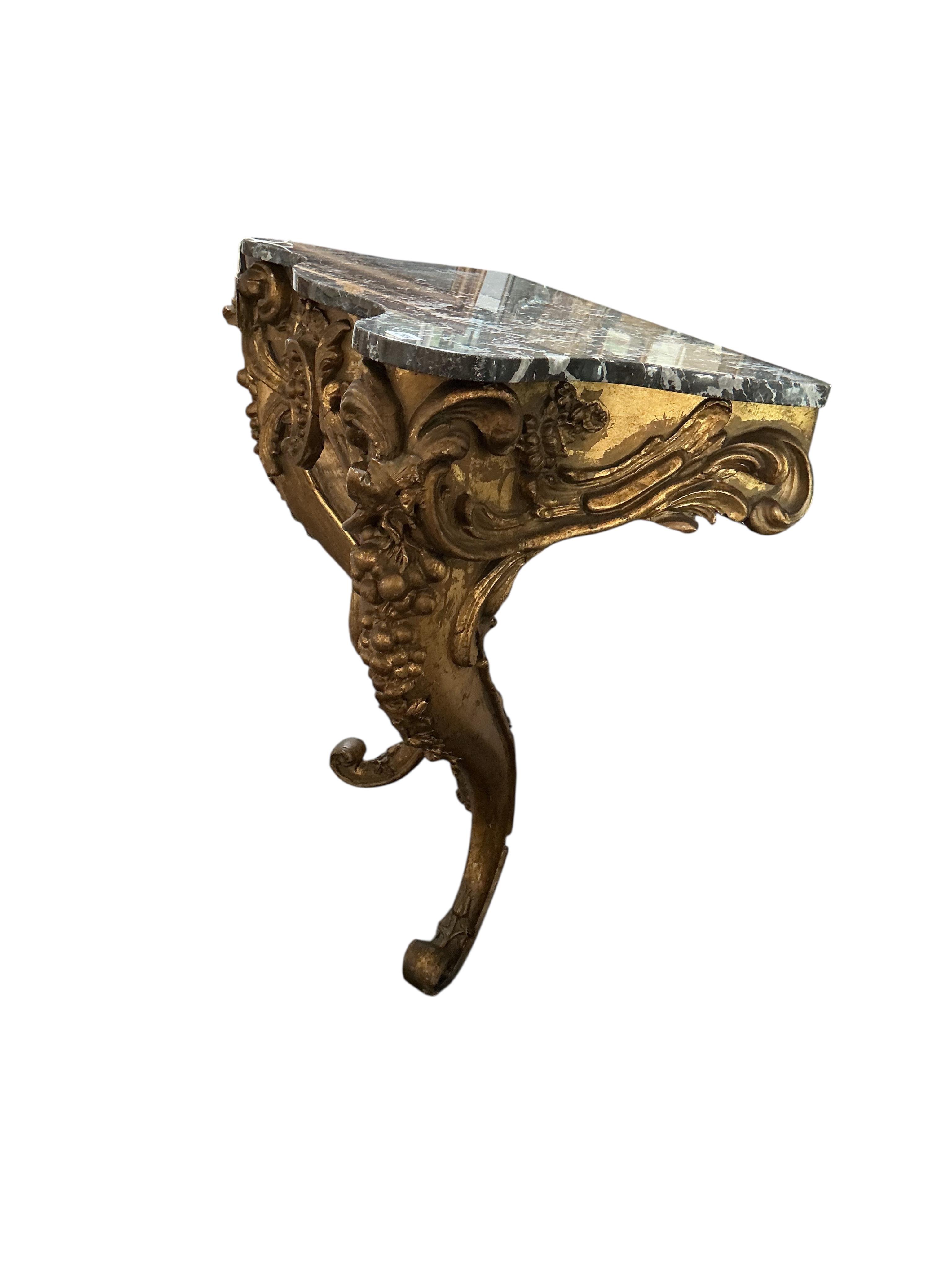 An 18th century Italian carved giltwood serpentine console table with associated marble top, width 85cm, depth 50cm, height 95cm